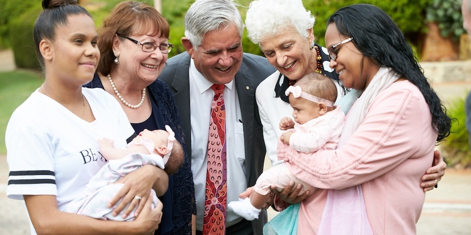 Family holding babies