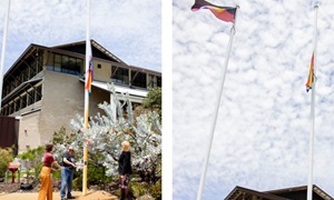 Murdoch student and staff member raising the Progress Pride Flag in 2021