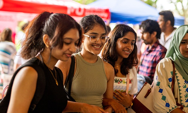 A group of students looking on at activities at Orientation day